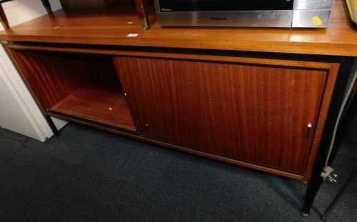 A Caplan Century teak sideboard, with two sliding doors, raised on a black metal frame, 73cm x...