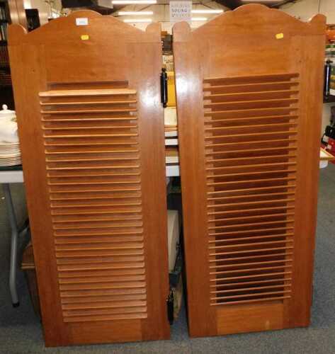 A pair of teak saloon doors, with louvred fronts, 131cm high, each 52cm wide.