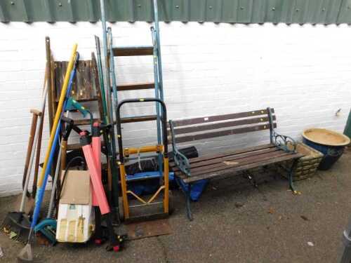 A two seater garden bench, with cast iron ends, three plant pots and planters, garden tools, a...
