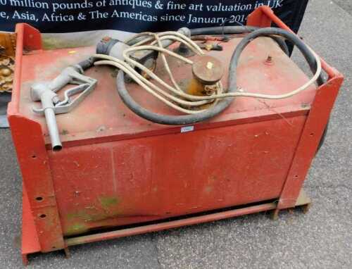 A red metal diesel fuel tank, with refuelling nozzle.