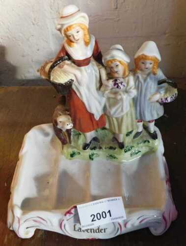 An early 20thC Yardley English Lavender porcelain soap dish, banded by three figures and a dog,...