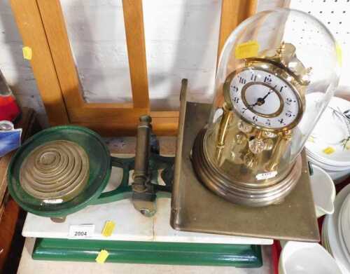 An anniversary clock, and a set of cast iron base scales.