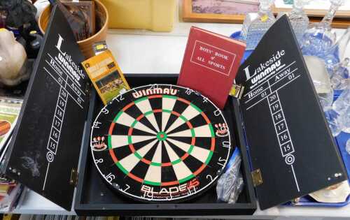 A Winmau Blade 5 dartboard, in fitted case, a 1966 World Cup football handbook, and The Boys...