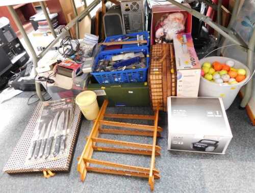 Assorted household effects, comprising souvenir spoon racks, battery chargers, wicker basket,...