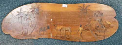 A Middle Eastern teak panel, depicting cattle and figures under palm trees.