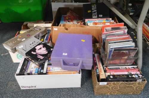 A quantity of Elvis memorabilia, to include DVDs, CDs, etc. (4 boxes)