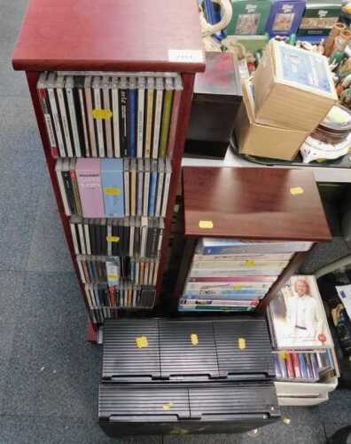 Two modern bookcases, each with CDs, books, and videos. (a quantity)