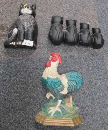 Three doorstops, comprising a cockerel doorstop, and two cat doorstops.