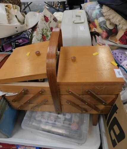 A cased Singer sewing machine, a cantilever sewing box and contents of needles and threads,...