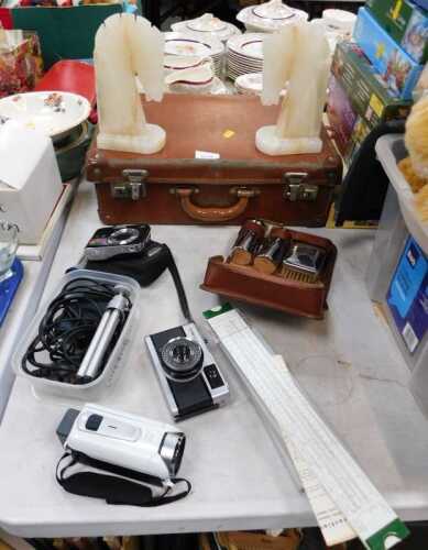 An Olympus Trip 35 camera, Canon Legria HFR46 camcorder, a pair of onyx horse head bookends,...