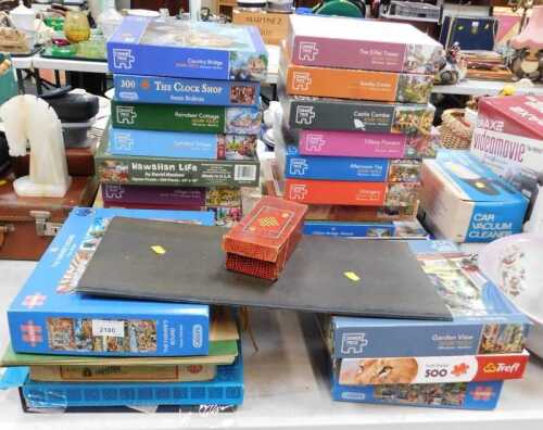 Assorted jigsaw puzzles, including Gibsons, Corner Piece, and Ravensburger, game of draughts, etc.