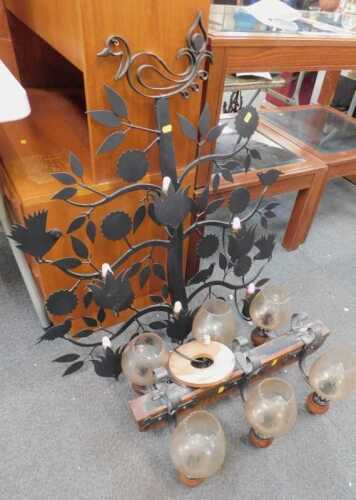 An oak ceiling light, with six glass shades, together with a black metal wall light, decorated...