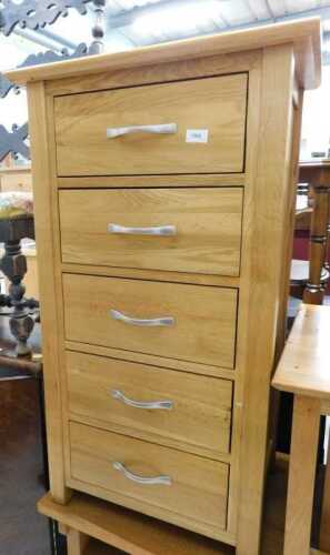 V - A light oak narrow chest, of five long drawers. Note: VAT is payable on the hammer price of this...