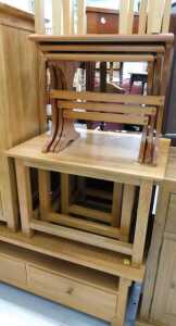 V - A light oak nest of three tables, teak finish nest of three tables, three further tables, and a...