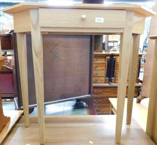 V - A light oak hall table, with canted top on square tapering legs. Note: VAT is payable on the...