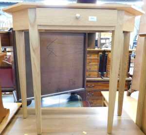 V - A light oak hall table, with canted top on square tapering legs. Note: VAT is payable on the...