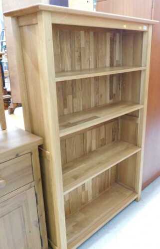 V - A light oak open bookcase, of four shelves. Note: VAT is payable on the hammer price of this lot...