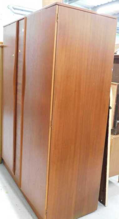 A teak double door wardrobe, and other furniture, a mid 20thC walnut bachelor's chest, of four...