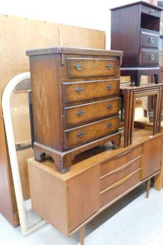 A 1970s teak sideboard, with three drawers flanked by cupboards on turned legs, a four door...