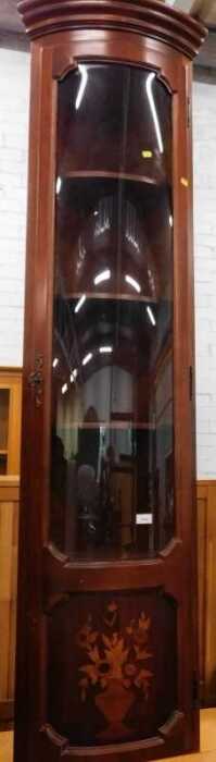 An Italian free-standing cylindrical corner cupboard, inlaid with vase of flowers.