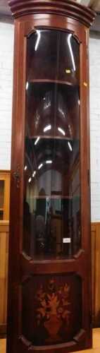 An Italian free-standing cylindrical corner cupboard, inlaid with vase of flowers.