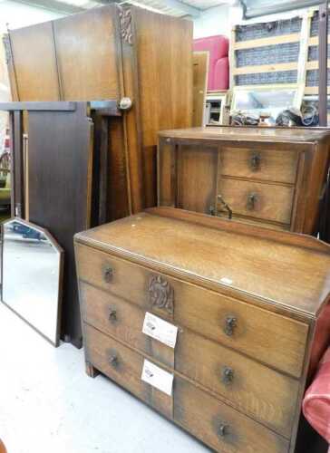 A mid-20thC oak bedroom suite, comprising double wardrobe, compactum chest, mirror back dressing...