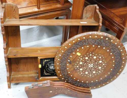 An Eastern pine finish hanging shelf, and a further heavily carved table with removable circular...