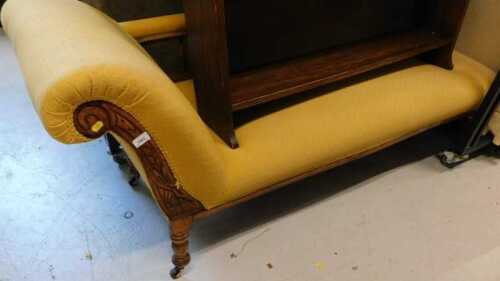 A heavily carved Edwardian chaise longe, in later diamond pattern gold coloured material.