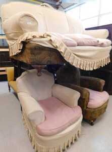 A three piece lounge suite, comprising three seater sofa and two armchairs, in floral and cream...