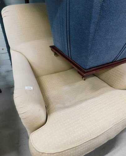 A single armchair in cream chequered material.