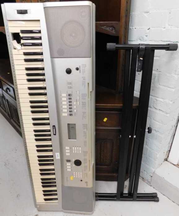 V - A Yamaha portable grand electric keyboard DGX-220 with stand. Note: VAT is payable on the hammer...