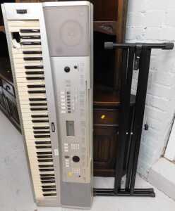 V - A Yamaha portable grand electric keyboard DGX-220 with stand. Note: VAT is payable on the hammer...