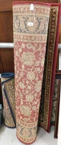 A machine woven rug, in red and blue floral pattern, and another smaller, in blue. (2)