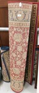 A machine woven rug, in red and blue floral pattern, and another smaller, in blue. (2)