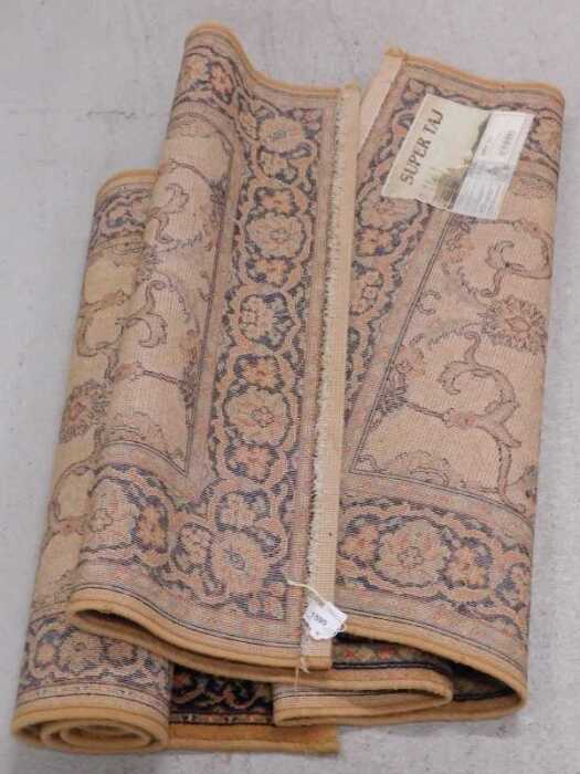 A Super Taj machine woven rug, and another.