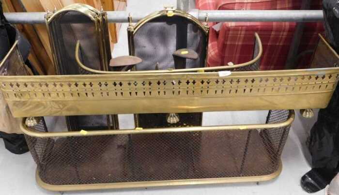 An early 20thC brass D-end fender, two three fold fire screens, a further brass fender of small...