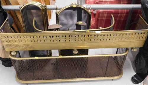 An early 20thC brass D-end fender, two three fold fire screens, a further brass fender of small...