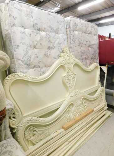 A Louis XV style matched French type bedroom suite, comprising king size bed, heavily carved...