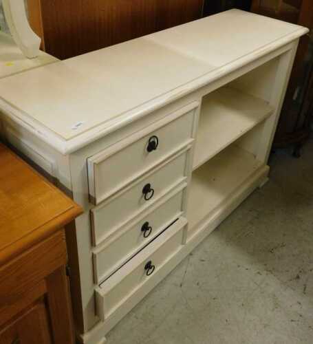 A side cabinet, with drawers aside open shelves painted cream.