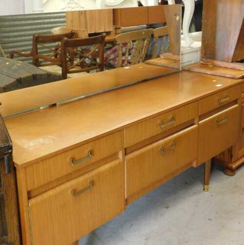 A teak mirror back dressing table, with six drawers, on square legs.