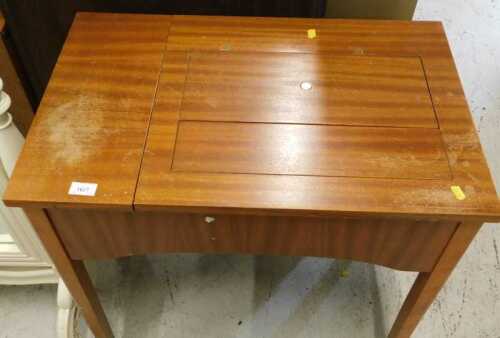 A teak freestanding Singer sewing machine, with articulated case.