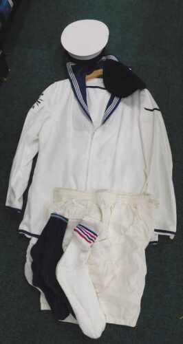 A late Royal Navy sailor's uniform, to include jacket and trousers, in white with blue trim,...