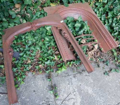 A late Victorian cast iron fire surround, and another. (2)