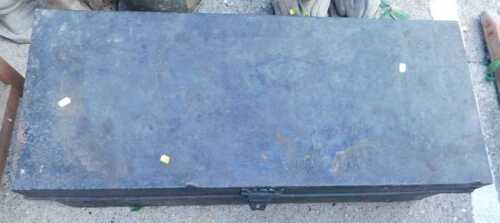 An early 20thC tin trunk, of rectangular form, with side carrying handles, in black.