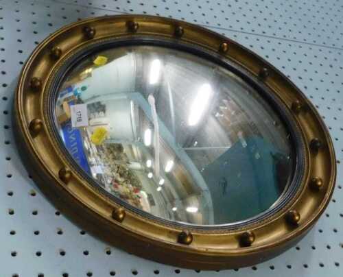A Regency style porthole mirror, of circular form, with beaded outline, late 20thC.