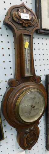 An early 20thC oak two dial barometer and thermometer.