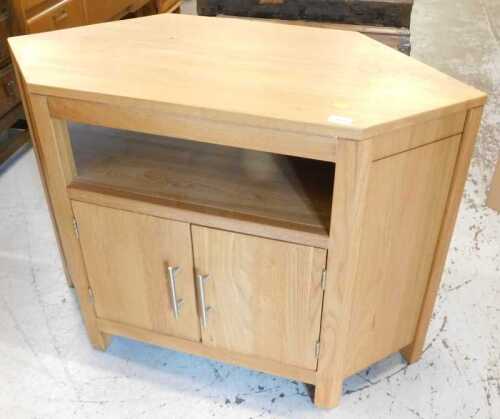 A light oak television stand, of shaped form.
