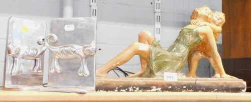 A painted chalk figurine of reclining lady with a child, together with a pair of aluminium...