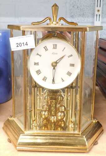 A Kundo brass anniversary clock, with white dial, Roman numerals, glass and brass cover etched...