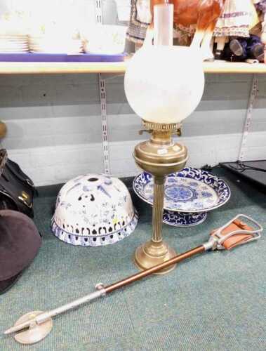 A large blue and white pierced bowl stand, together with a brass oil lamp or column, and a...
